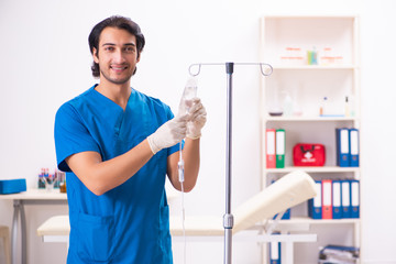 Young male doctor in blood transfusion concept 