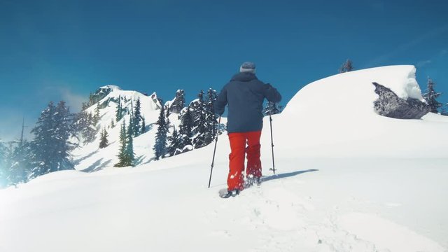 Snowshoe Adventure in Fresh Deep Powder Snow to Summit Peak with Blue Sky