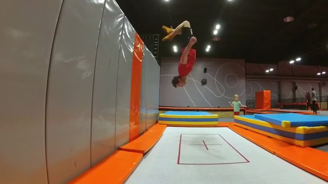 Trampoline Wall Jumping Backflip Practiced by Young Man Slow Motion