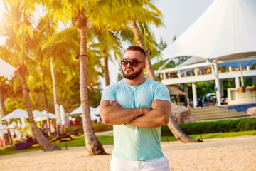 Young man on a tropical beach. Summer