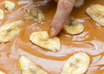 fruit cake with milk cream and fruit and showing a man's hand