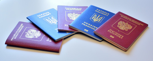 Russian and Ukrainian international passports on white background. Isolated