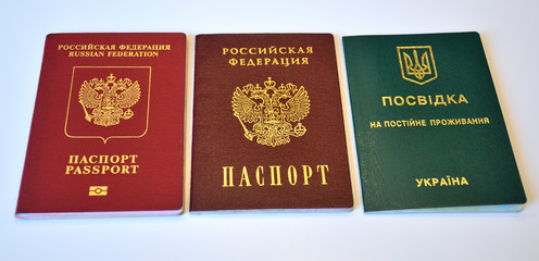 Russian domestic, foreign passports and Ukrainian Permanent Residence Card on white background. Isolated