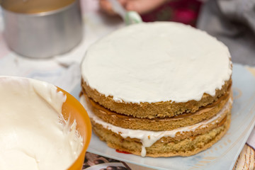 application of milk cream on the surface of the sweet cake