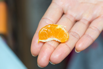 a piece of orange in hand