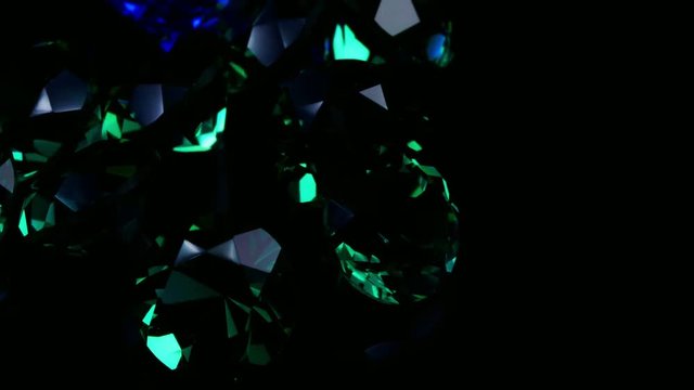 Gemstones rotate on a stand on a black background. Close up.