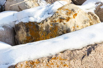 huge stones in the snow of different shapes and sizes, natural stone, winter background