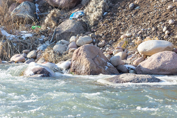 Mountain river and stones in winter