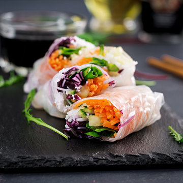 Vegetarian vietnamese spring rolls with spicy sauce, carrot, cucumber, red cabbage and rice noodle. Vegan food. Tasty meal.  Copy space