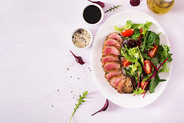 Japanese traditional salad with pieces of medium-rare grilled Ahi tuna and sesame with fresh...