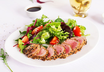 Japanese traditional salad with pieces of medium-rare grilled Ahi tuna and sesame with fresh...
