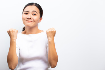 Happy woman with raised hands and celebrating standing isolated over white background