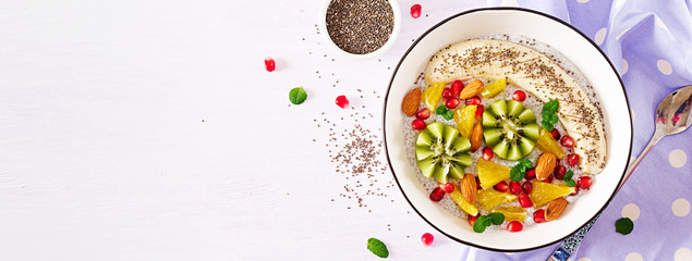 Delicious and healthy chia pudding with banana, kiwi and chia seeds. Healthy breakfast. Fitness food. Proper nutrition. Flat lay. Top view. Banner