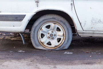 Fototapeta na wymiar car wheel flat tire on the road