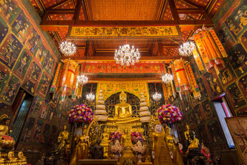Fototapeta na wymiar Big Golden Buddha Statue in the ubosot at Wat Phanan Choeng temple, Ayutthaya, Thailand, World Heritage Site.