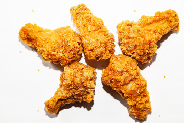 Close-up of fried delicious, appetizing five chicken wings made from fresh meat in a spicy sauce and breaded a popular dish in restaurants and fast food lie on isolated background inthe form of star