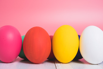 Easter eggs clean on wooden and pink background