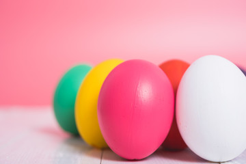 Easter eggs clean on wooden and pink background