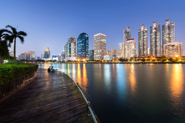 Fototapeta na wymiar City downtown at night and business district of bangkok with water reflection of skyline, taken from Benjakitti park on Ratchadapisek Road Bangkok, Thailand