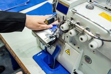Overlock sewing machine / seaming machine / edger in garment factory workshop