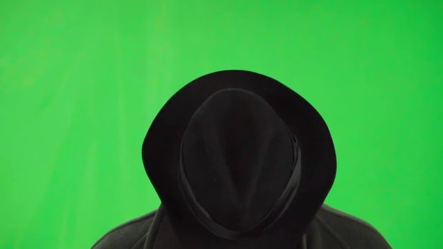 Brutal bearded man with hat up head and strong look green screen shot