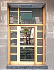 Greece Athens downtown, 60's elegant condominium entrance golden colored frame door