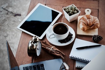 cup of coffee and notebook on wooden table