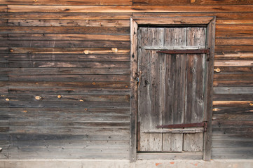 Front view: old rustic wooden wall and door