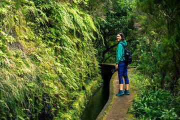 Portrait of young girl in green sweatshirt walking by levana on Madeira island, up in mountains....