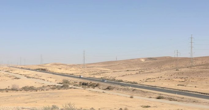 Road in desert  Negev with moving cars at winter