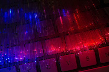 Colourful optic fibers illuminated on dark background. High speed internet concept. Data transfer...