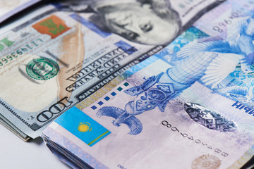 Obraz na płótnie Canvas Dollars and tenge. American and Kazakh money close up