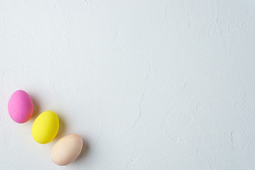 happy easter, spring holidays, greeting card or festive banner template. painted colored eggs on stone background.