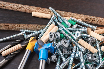 Tools for furniture assembly on a wooden background closeup