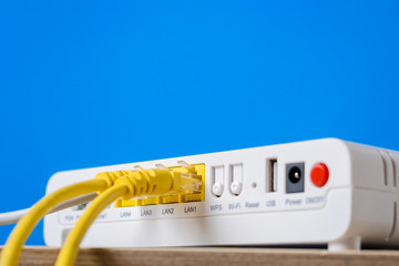 wireless internet router with connecting cables on a blue background