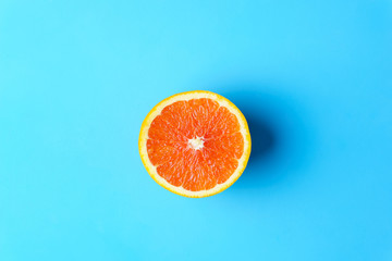 summer background, tropical beach, vacation, fruit minimal concept. creative layout of orange slice on bright blue background