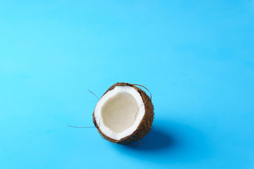 summer background, tropical beach, vacation, fruit minimal concept. creative layout of coconut on bright blue background with copy space