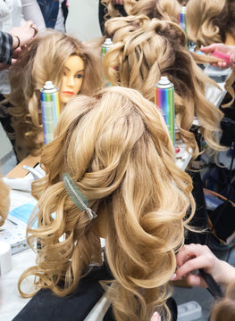 Learning hairstyles on the heads of mannequins.