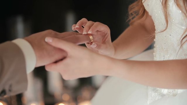 The bride puts the wedding ring on finger of the groom. marriage hands with rings. The bride and groom exchange wedding rings.