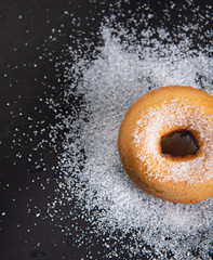 Fototapeta na wymiar Donut sprinkled with sugar. Donut sprinkled with Granulated sugar