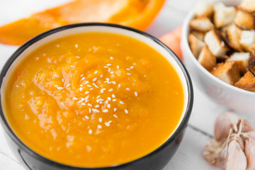 pumpkin soup with sesame, vegetable soup, a piece of pumpkin, garlic
