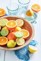 Sweet oranges, limes and lemons with on rustic table