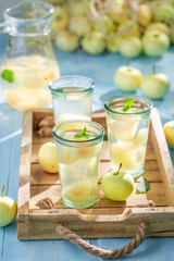 Tasty apple juice on blue wooden table