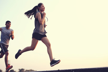 Asia couple men and women run in the morning..With workspace