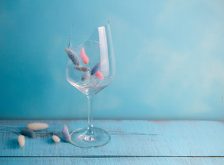 broken glass of wine on blue wooden background