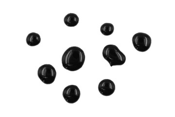Dripping black paint isolated on white background. Flowing fuel oil splashes, drops and trail