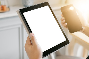 hand showing digital tablet and phone blank screen on work desk