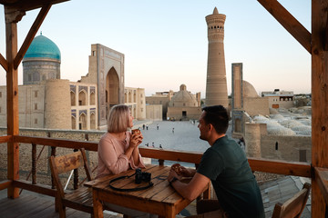 Tourist Man Woman Drink Coffee on Mosque View