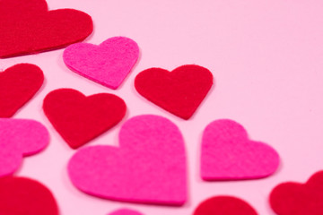 Obraz premium White Saint Valentine's day background with red and pink hearths, close-up view, copy space