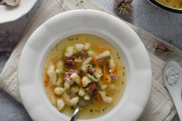 Smoked meat soup with pasta inside